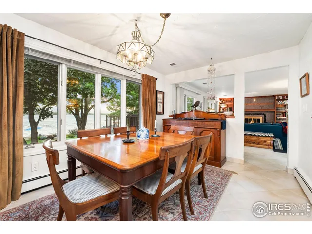a living room with furniture a rug and a floor to ceiling window