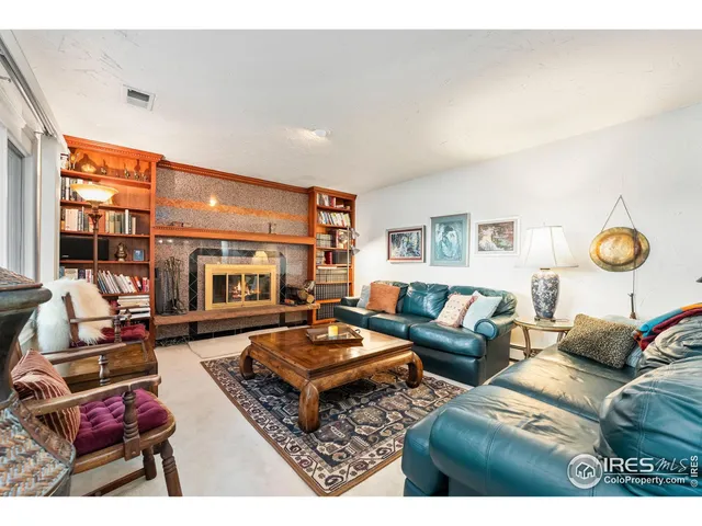 a living room with furniture a rug and a large window