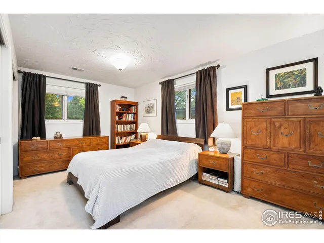 a bedroom with bed and window