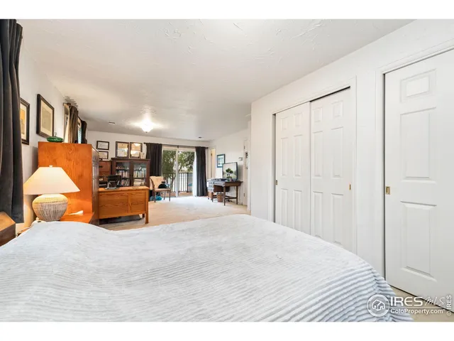 a bedroom with furniture and large window