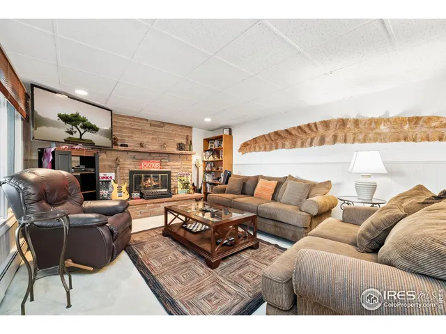 a living room with furniture a large window and a table