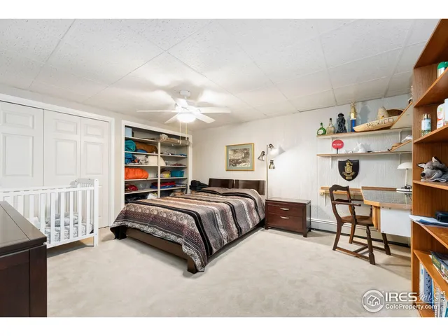 a bedroom with two beds and a chandelier