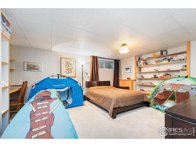 a bedroom with a bed gym equipment and a large window