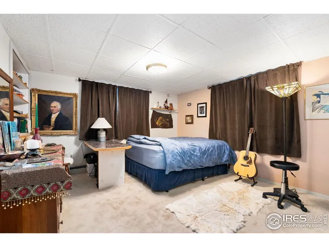 a bed room with a bed and a large window