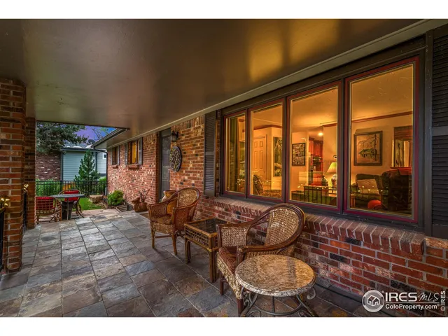 a balcony with furniture and a large window