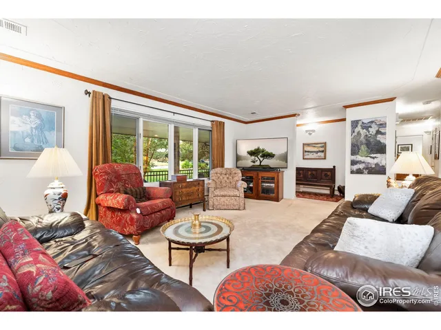 a living room with furniture wooden floor and a table