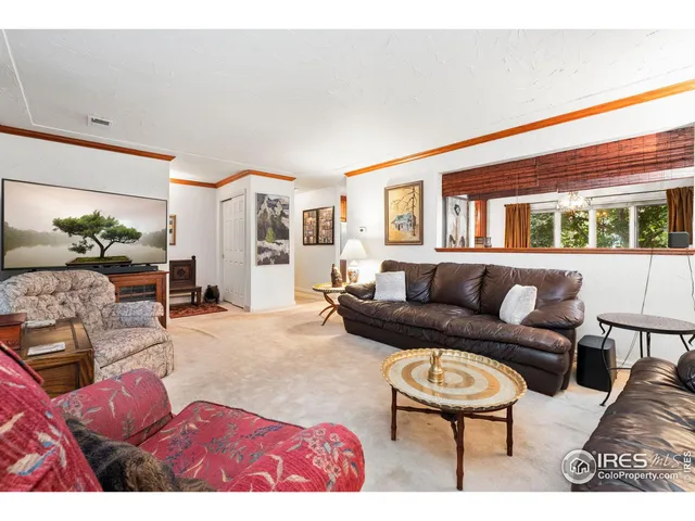 a kitchen with stainless steel appliances kitchen island granite countertop a refrigerator a stove a sink with island chairs and wooden cabinets