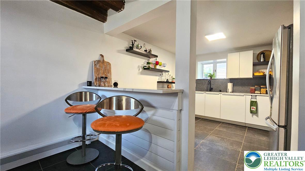 2239 Wassergass Road Hellertown, PA 18055 - Photo 21 of 42 a kitchen with stainless steel appliances a sink a window and a dining table
