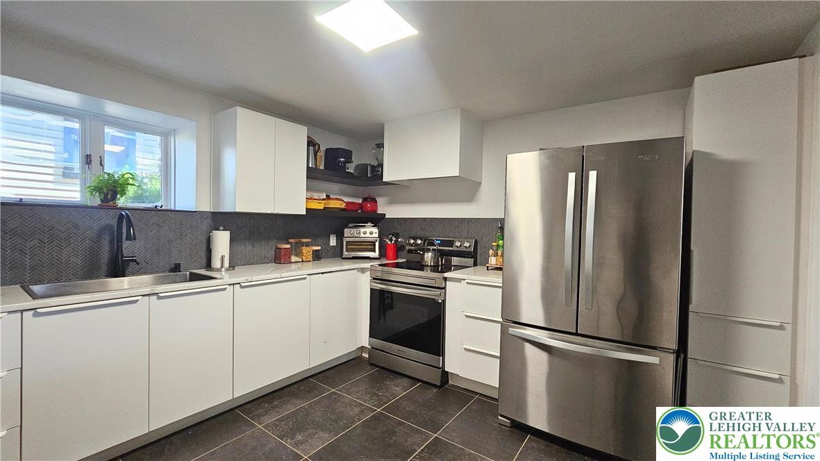 2239 Wassergass Road Hellertown, PA 18055 - Photo 22 of 42 a kitchen with stainless steel appliances a refrigerator sink and microwave