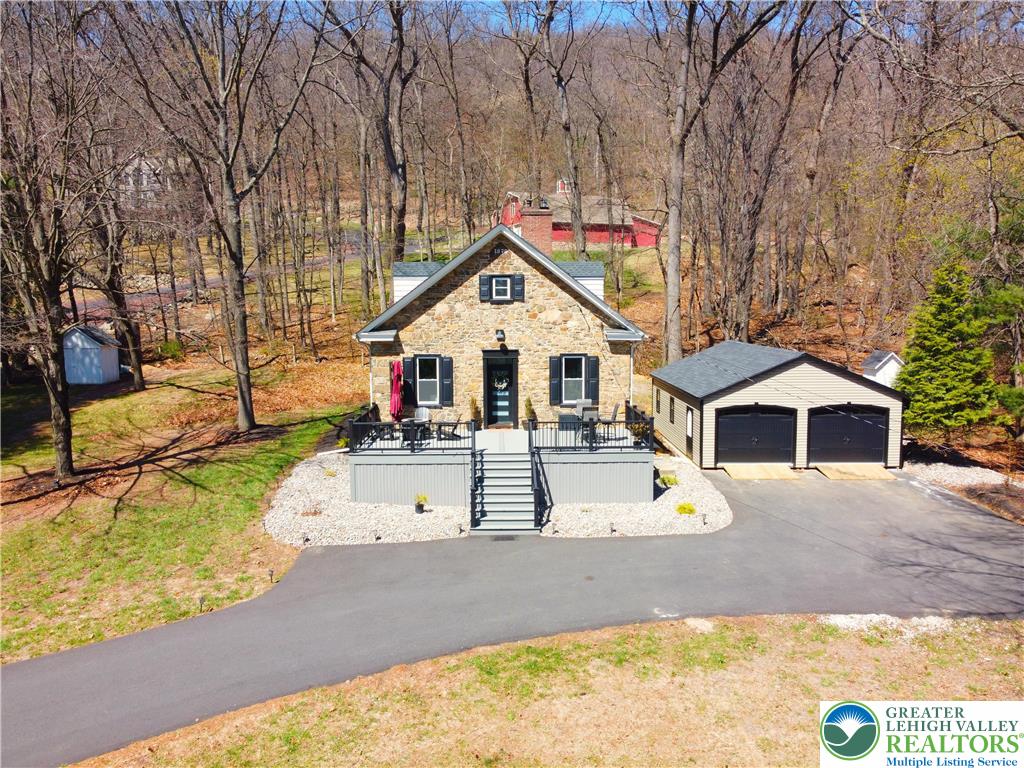 2239 Wassergass Road Hellertown, PA 18055 - Photo 3 of 42 a view of a white house with large trees and wooden fence