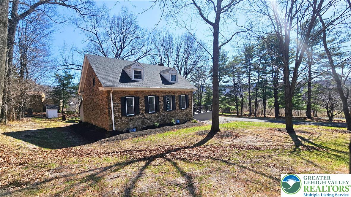 2239 Wassergass Road Hellertown, PA 18055 - Photo 38 of 42 a view of a house with a yard covered with snow in the background