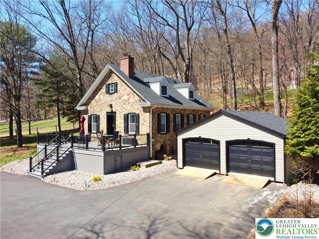2239 Wassergass Road Hellertown, PA 18055 - Photo 4 of 42 a front view of a house with yard and trees in the background