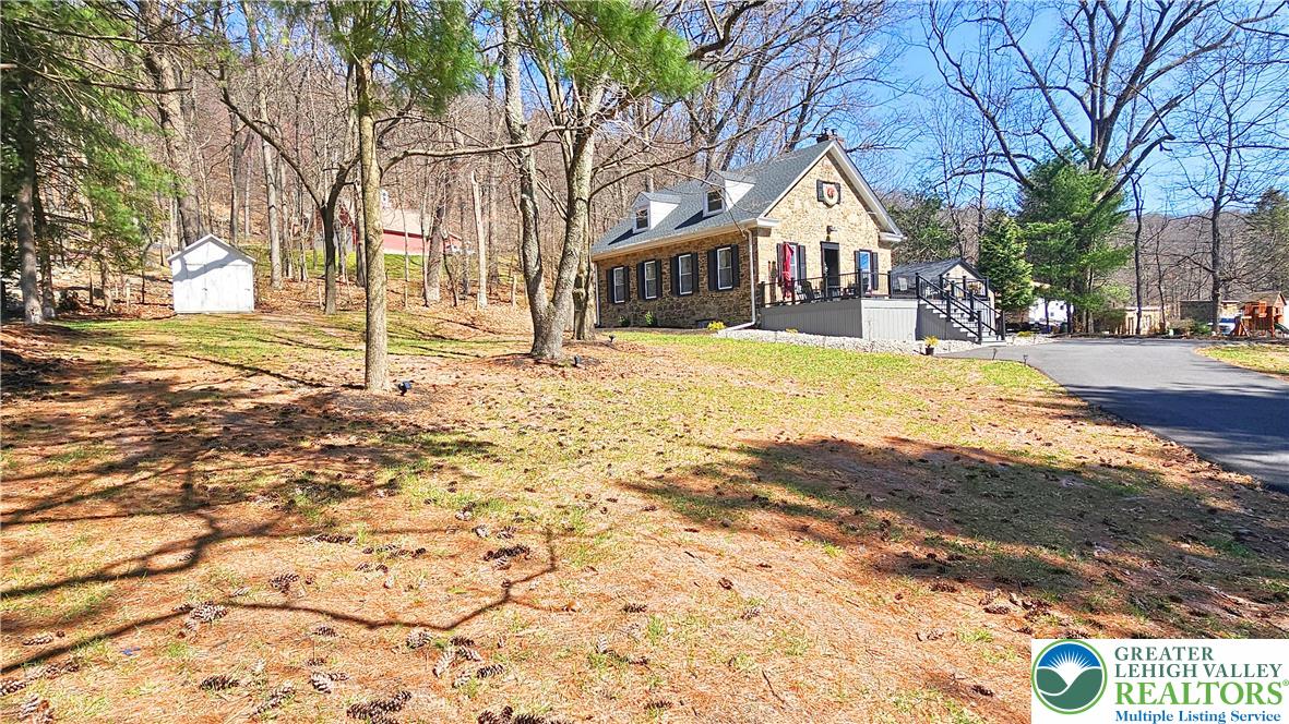 2239 Wassergass Road Hellertown, PA 18055 - Photo 42 of 42 a front view of a house with a yard covered with snow
