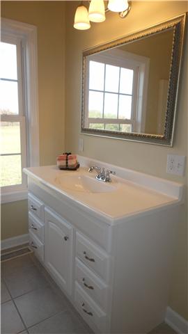 708 Barrett Road McMinnville, TN 37110 - Photo 10 of 20 Downstairs bedrooms share a conveniently located bath tub and shower combo, vanity with storage and tile floor.
