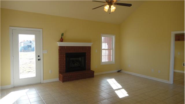 708 Barrett Road McMinnville, TN 37110 - Photo 2 of 20 Living Room will surely become a favorite room with its lighted ceiling fan, tile floor, and fireplace.
