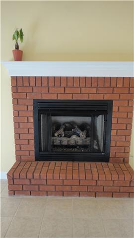 708 Barrett Road McMinnville, TN 37110 - Photo 3 of 20 Brick Fireplace with mantle in Living Room enhances the coziness of the room inviting you to snuggle around the fire to watch TV or movies with a bag of popcorn.