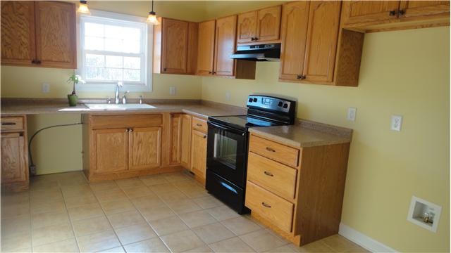 708 Barrett Road McMinnville, TN 37110 - Photo 5 of 20 With windowed double sink, the kitchen offers generious cabinets with copious storage behind doors and in drawers.