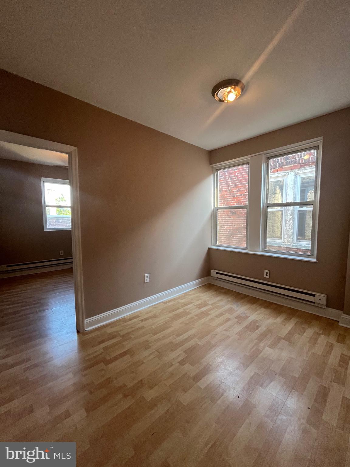 207 South 60th Street, Unit 3 Philadelphia, PA 19139 - Photo 2 of 14 an empty room with wooden floor and windows