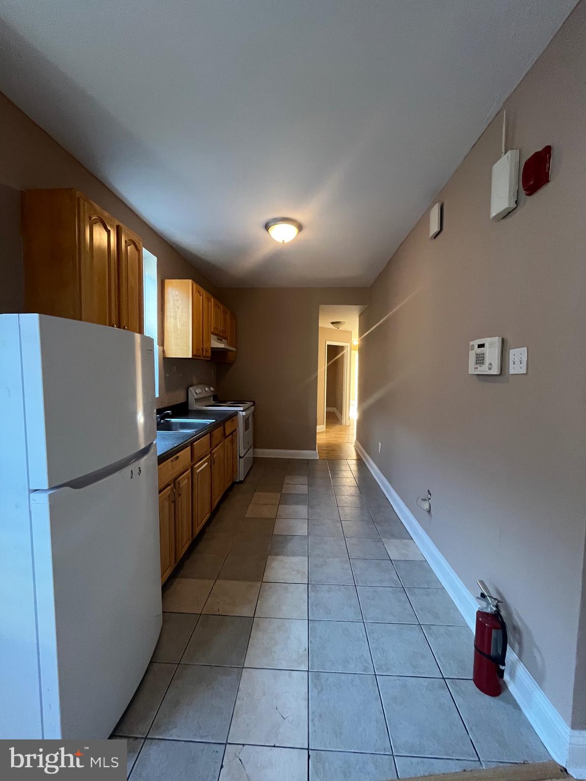 207 South 60th Street, Unit 3 Philadelphia, PA 19139 - Photo 4 of 14 a kitchen with a refrigerator and a sink
