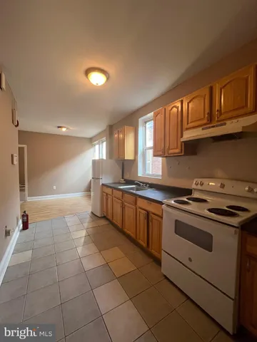 a large kitchen with stainless steel appliances granite countertop a stove and a sink