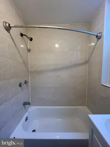 a bathroom with a shower and a bath tub