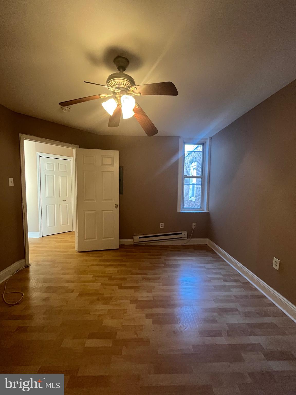 207 South 60th Street, Unit 3 Philadelphia, PA 19139 - Photo 10 of 14 a view of an empty room with window and wooden floor