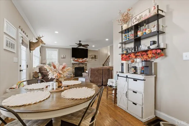 a kitchen with stainless steel appliances granite countertop a stove top oven a sink dishwasher and a refrigerator with wooden floor