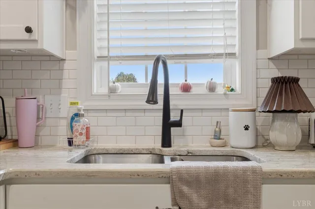 a kitchen with kitchen island a stove a table and chairs in it