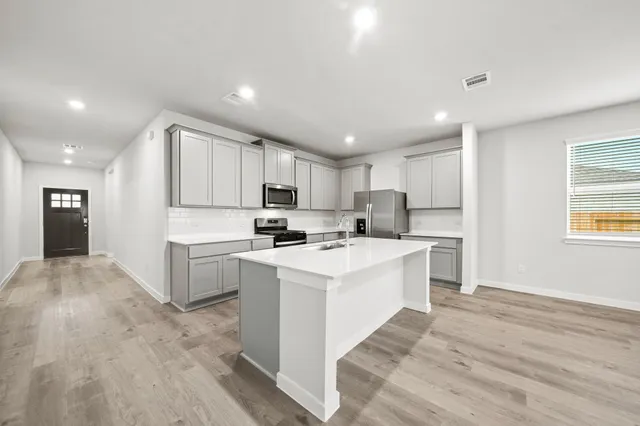 a kitchen with white cabinets and white appliances