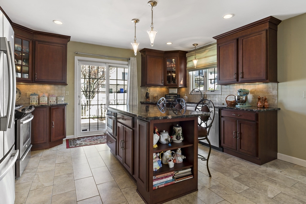 34 Howland Street Fall River, MA 02724 - Photo 12 of 42 a kitchen with stainless steel appliances granite countertop a stove top oven a sink dishwasher and cabinets with wooden floor