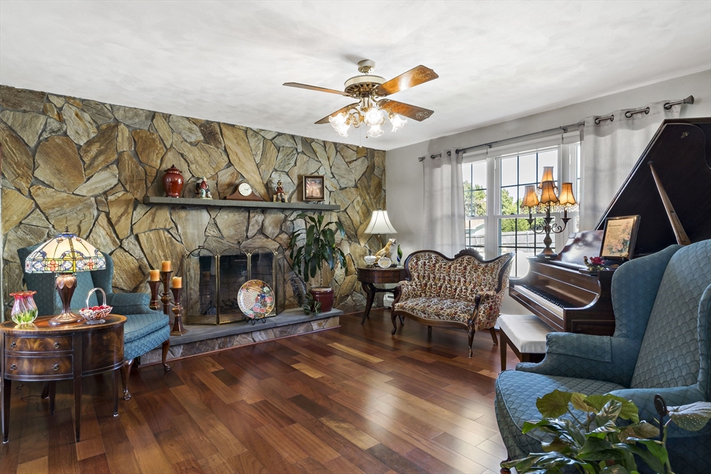 34 Howland Street Fall River, MA 02724 - Photo 19 of 42 a living room with furniture a fireplace and a flat screen tv
