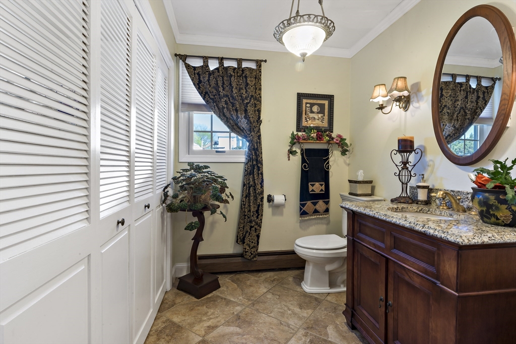 34 Howland Street Fall River, MA 02724 - Photo 24 of 42 a bathroom with a toilet a sink and a mirror