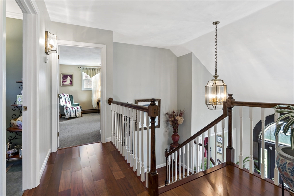 34 Howland Street Fall River, MA 02724 - Photo 25 of 42 a view of a hallway with wooden floor and stairs