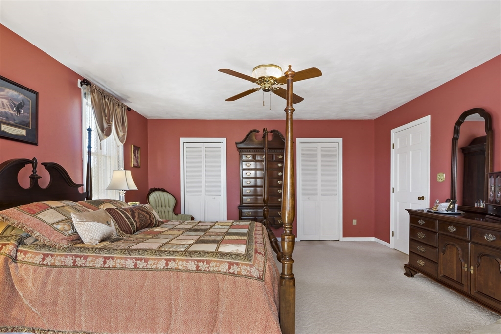 34 Howland Street Fall River, MA 02724 - Photo 27 of 42 a bedroom with a bed and dresser with mirror