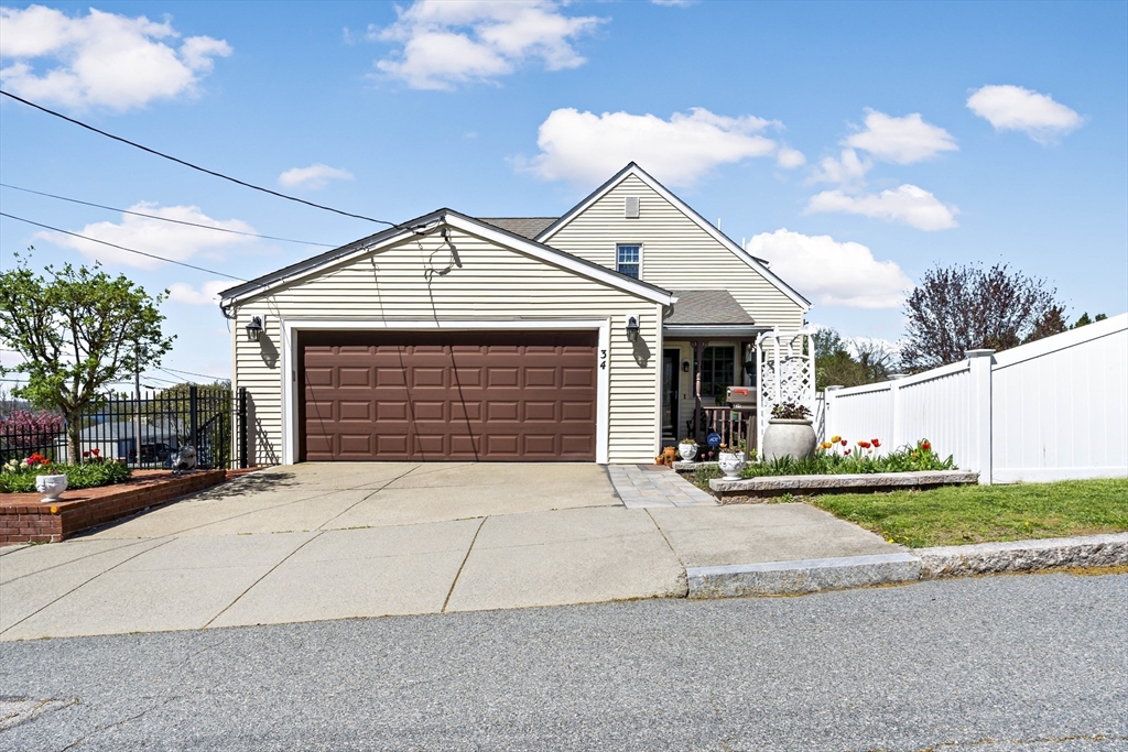 34 Howland Street Fall River, MA 02724 - Photo 3 of 42 a front view of a house with a yard and garage
