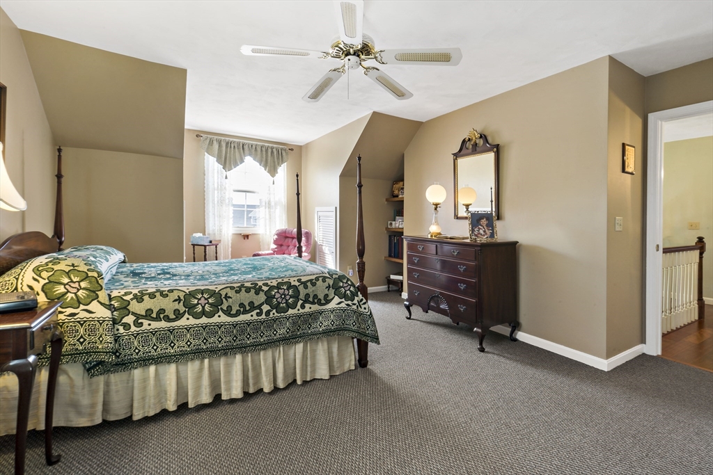 34 Howland Street Fall River, MA 02724 - Photo 32 of 42 a bedroom with a bed and a chandelier