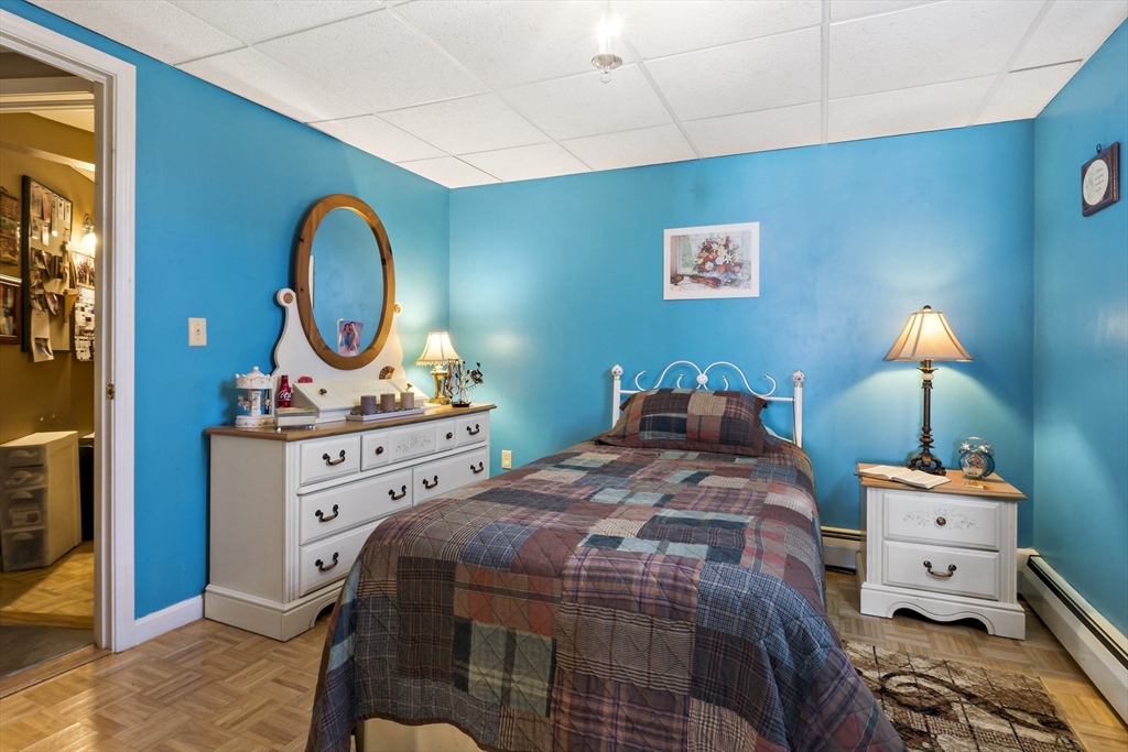 34 Howland Street Fall River, MA 02724 - Photo 42 of 42 a bedroom with a bed and a lamp on the table