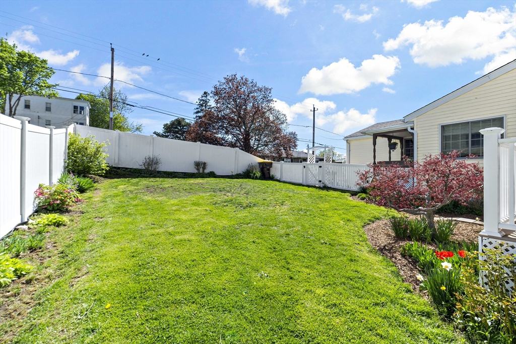 34 Howland Street Fall River, MA 02724 - Photo 6 of 42 a view of a house with a big yard and potted plants