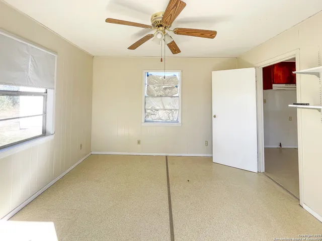 a view of a kitchen with a sink and a refrigerator
