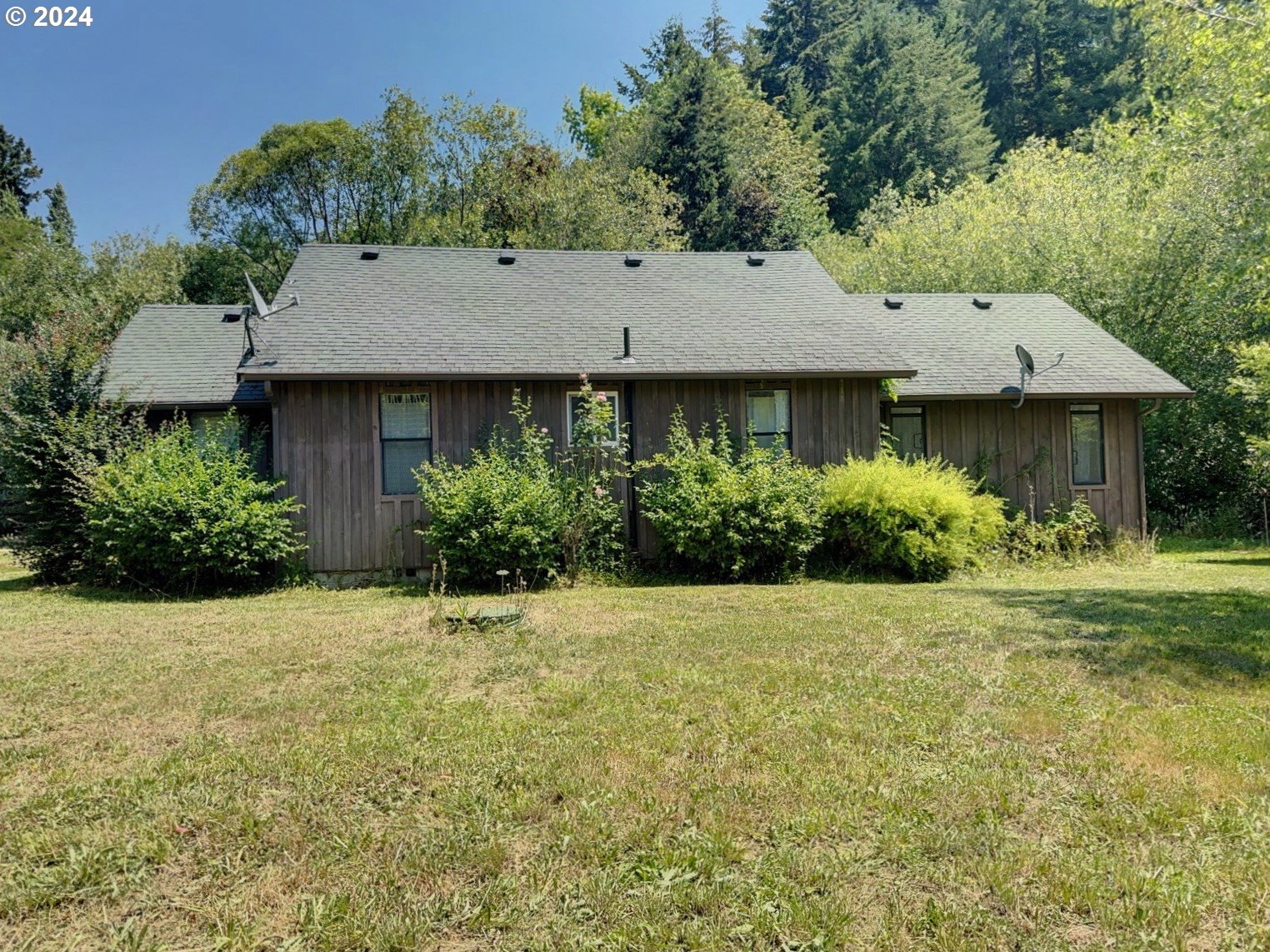 98368 Bridge Lane Myrtle Point, OR 97458 - Photo 1 of 37 a front view of a house with a garden