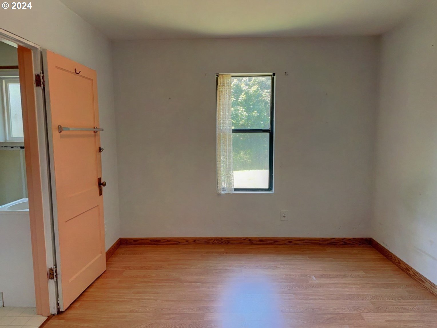 98368 Bridge Lane Myrtle Point, OR 97458 - Photo 13 of 37 an empty room with wooden floor and windows