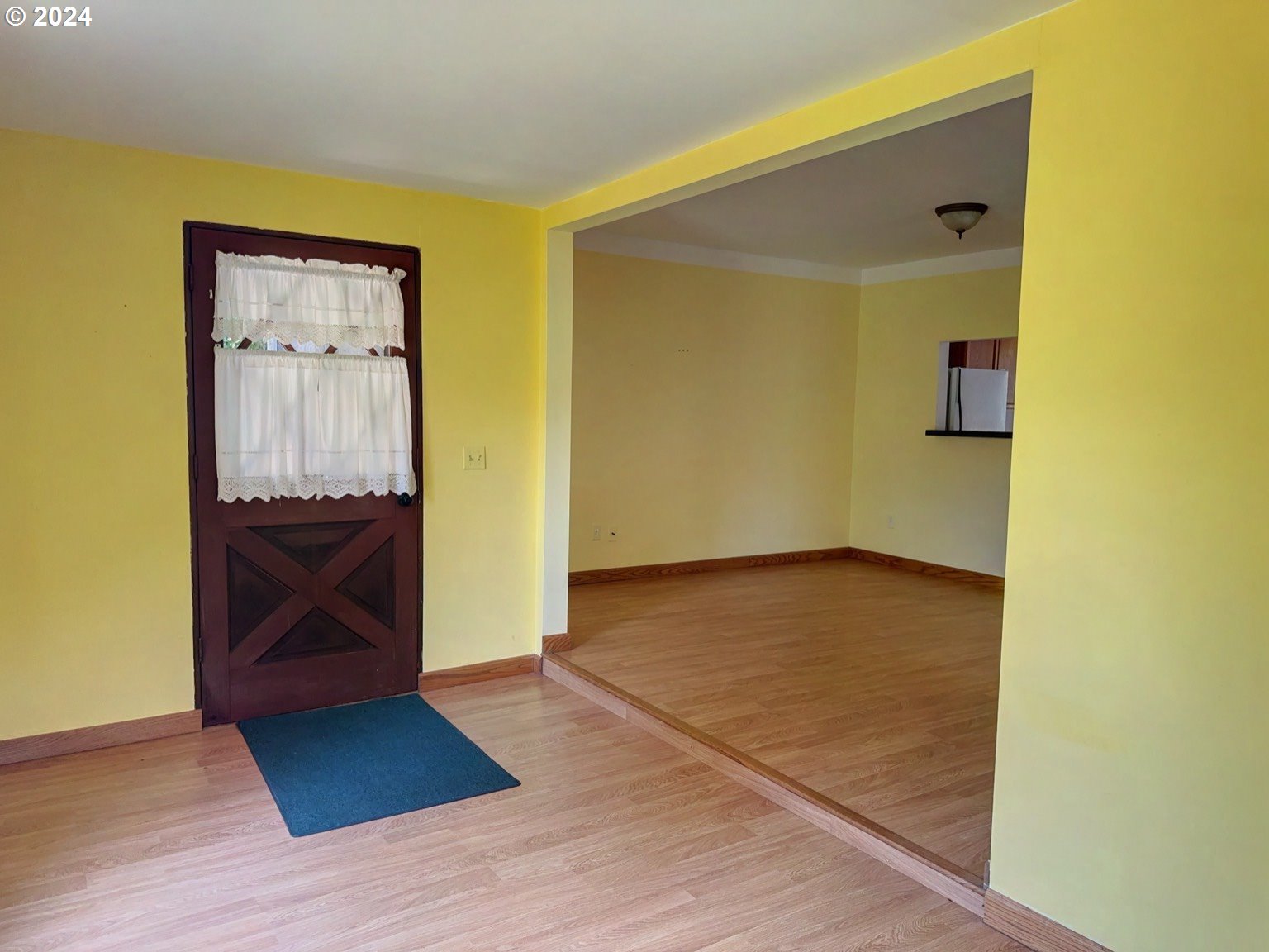 98368 Bridge Lane Myrtle Point, OR 97458 - Photo 5 of 37 a view of a hallway with wooden floor and a bathroom