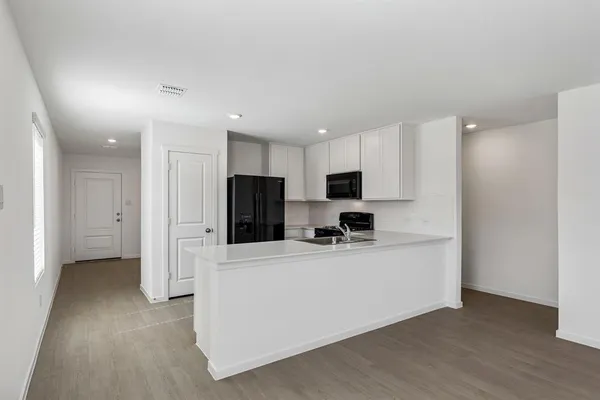 a kitchen with stainless steel appliances a refrigerator and a stove top oven
