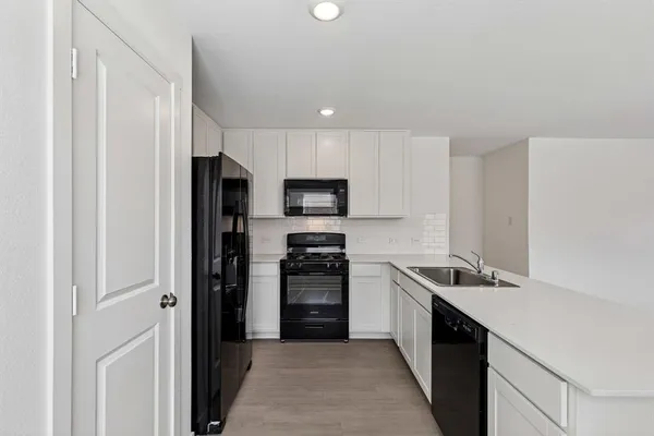 a kitchen with a refrigerator stove and microwave