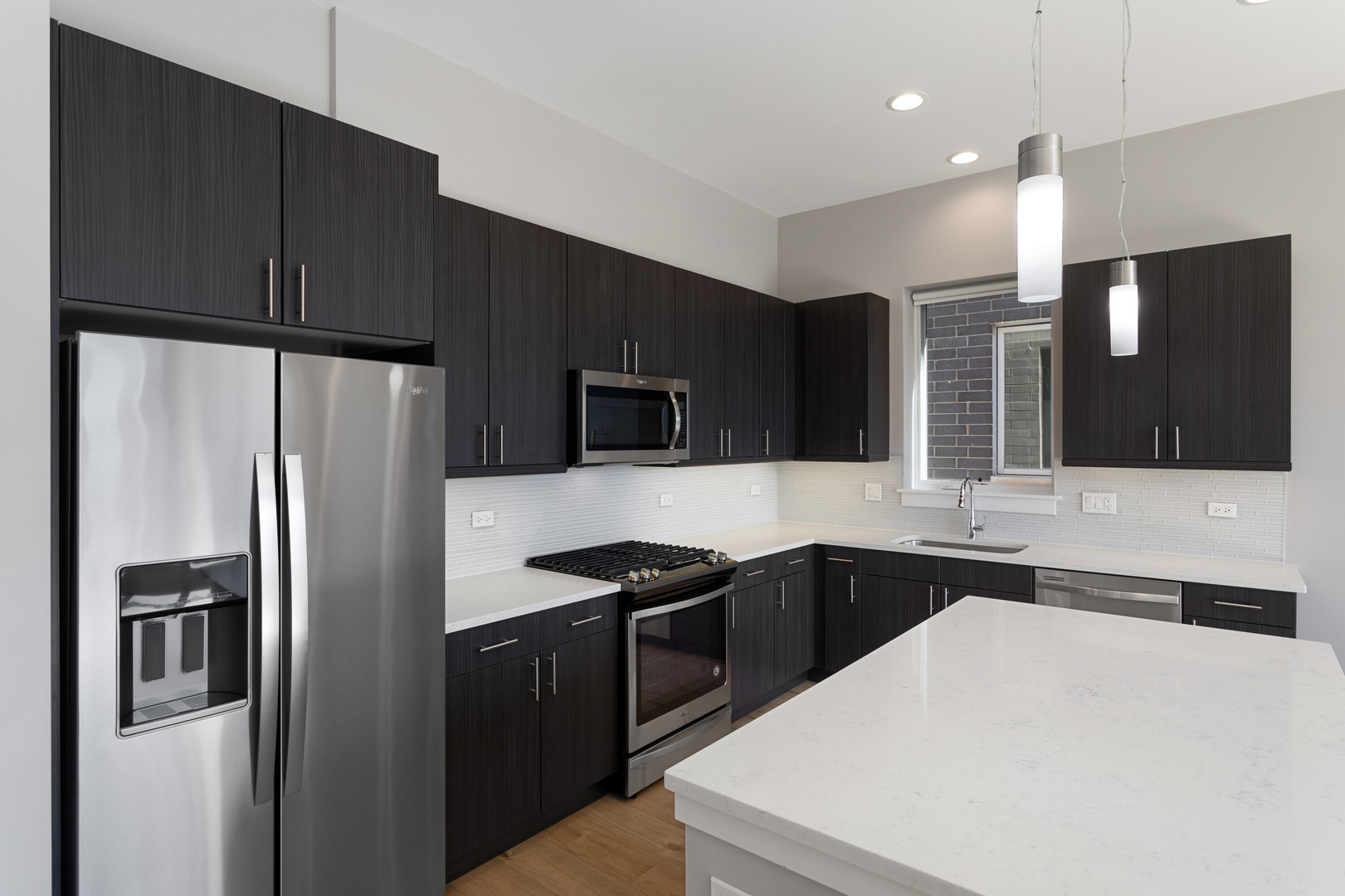 2518 West Addison Street, Unit 3W Chicago, IL 60618 - Photo 4 of 23 a kitchen with stainless steel appliances a refrigerator sink and microwave