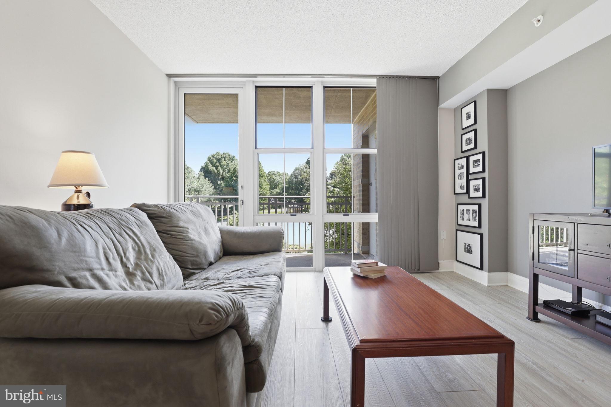 11800 Sunset Hills Road, Unit 218 Reston, VA 20190 - Photo 16 of 38 a living room with furniture and a window