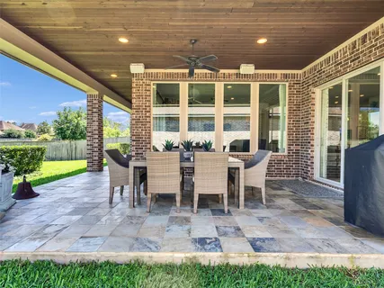 a living room with furniture and floor to ceiling windows