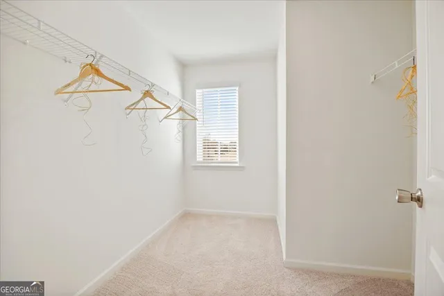 a view of small space with white walls and a window