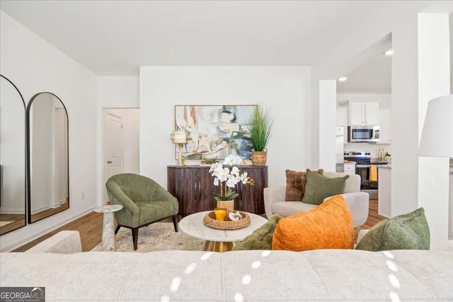 a living room with furniture and wooden floor