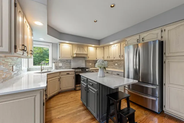 a kitchen with granite countertop a sink appliances cabinets and counter space